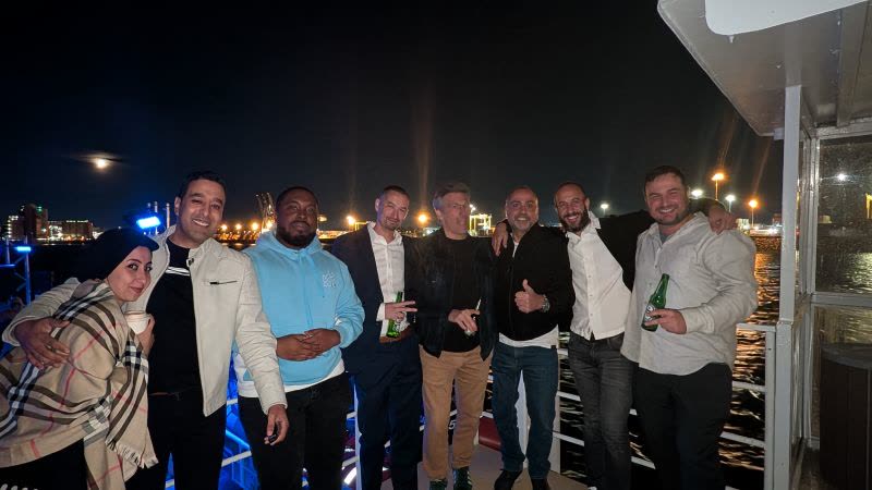 The RENAPS team posing together on the deck of the boat at night